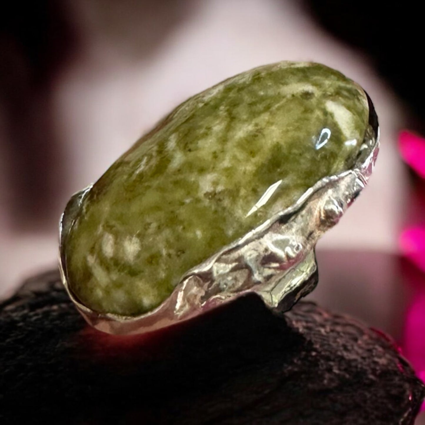 a silver ring with a precious stone